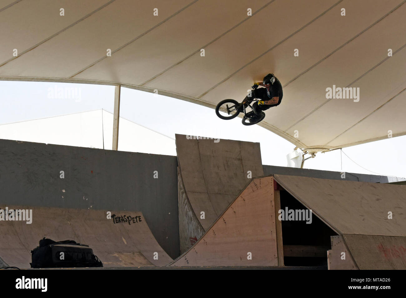 A Bikes Over Baghdad BMX rider jumps over a ramp at Al Udeid Air Base, Qatar, April 20, 2017