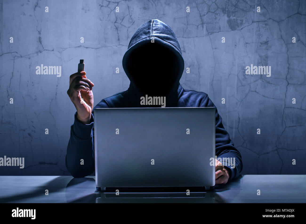 Hacker using laptop. Hacking the Internet. Stock Photo