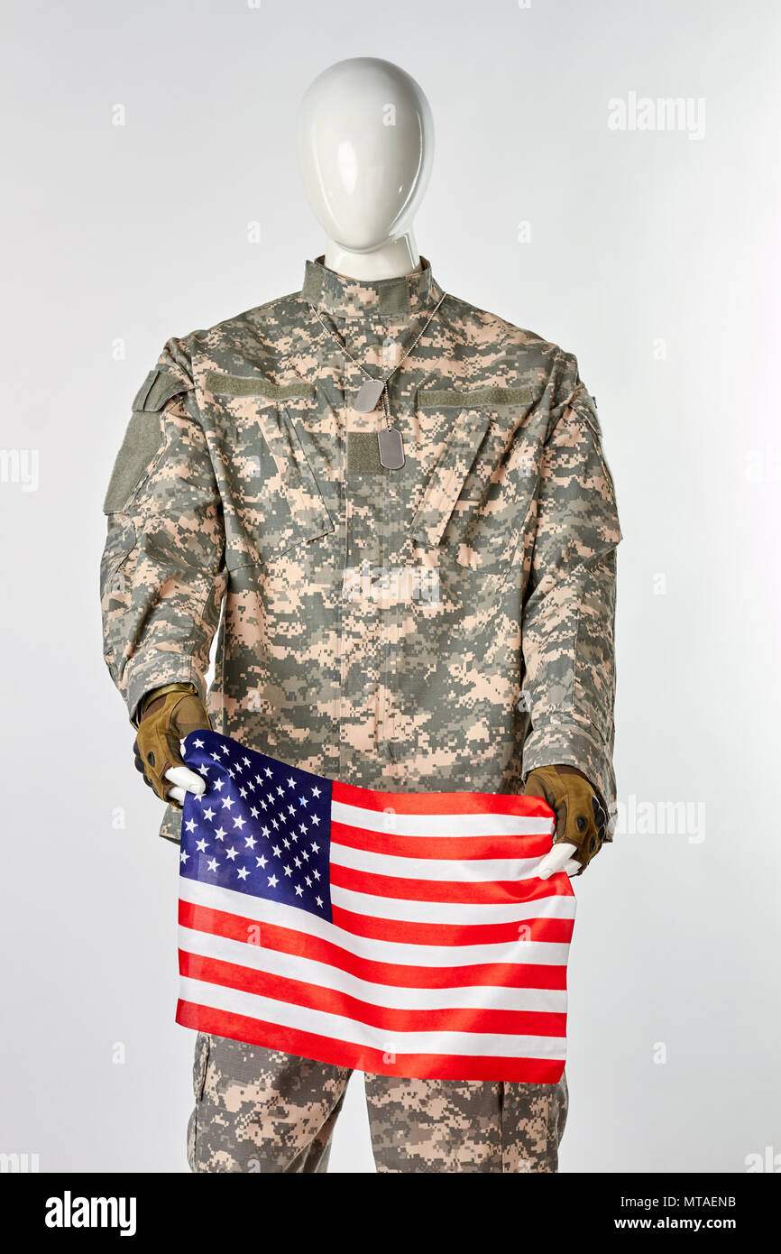 Mannequin in military army uniform holding american flag. Portrait of