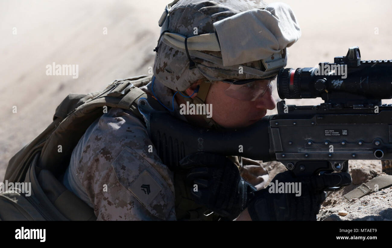 U.S. Marine Corps Cpl. Ryan H. Weston, a machine gunner with 1st Battalion, 7th Marine Regiment, Special Purpose Marine Air-Ground Task Force-Crisis Response-Central Command, holds his security position during a Tactical Recovery of Aircraft and Personnel exercise while forward deployed in the Middle East, April 20, 2017. SPMAGTF Marines consistently train to enhance their ability to react to any mission they may encounter while conducting USCENTCOM’s crisis response mission. Stock Photo
