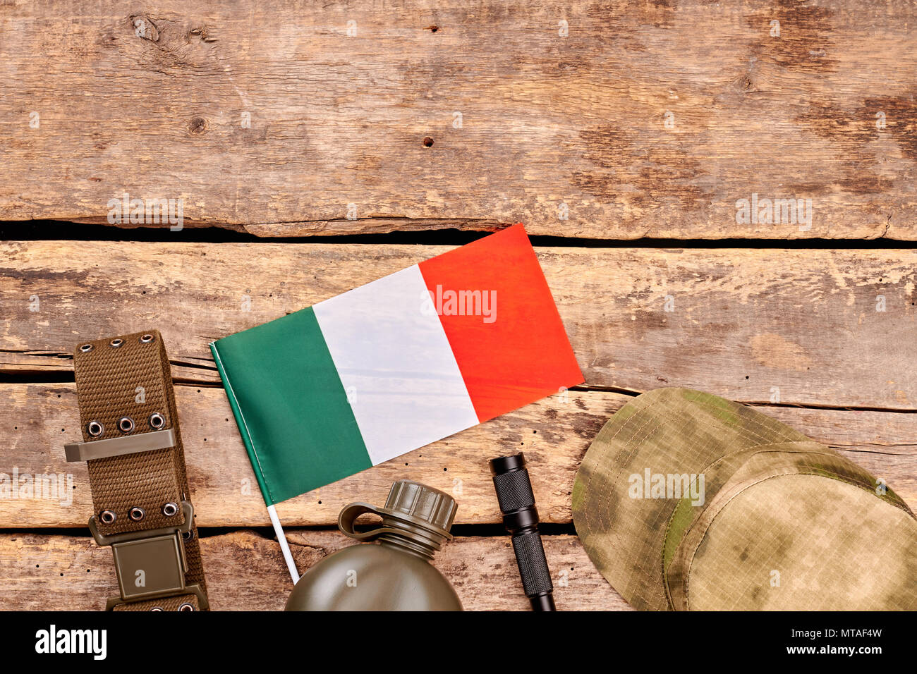 Accessories of italian army soldier. Flat lay, top view. Wooden desk ...