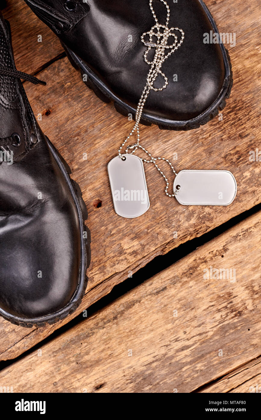 Military army boots and dog tags. Wooden background Stock Photo Alamy