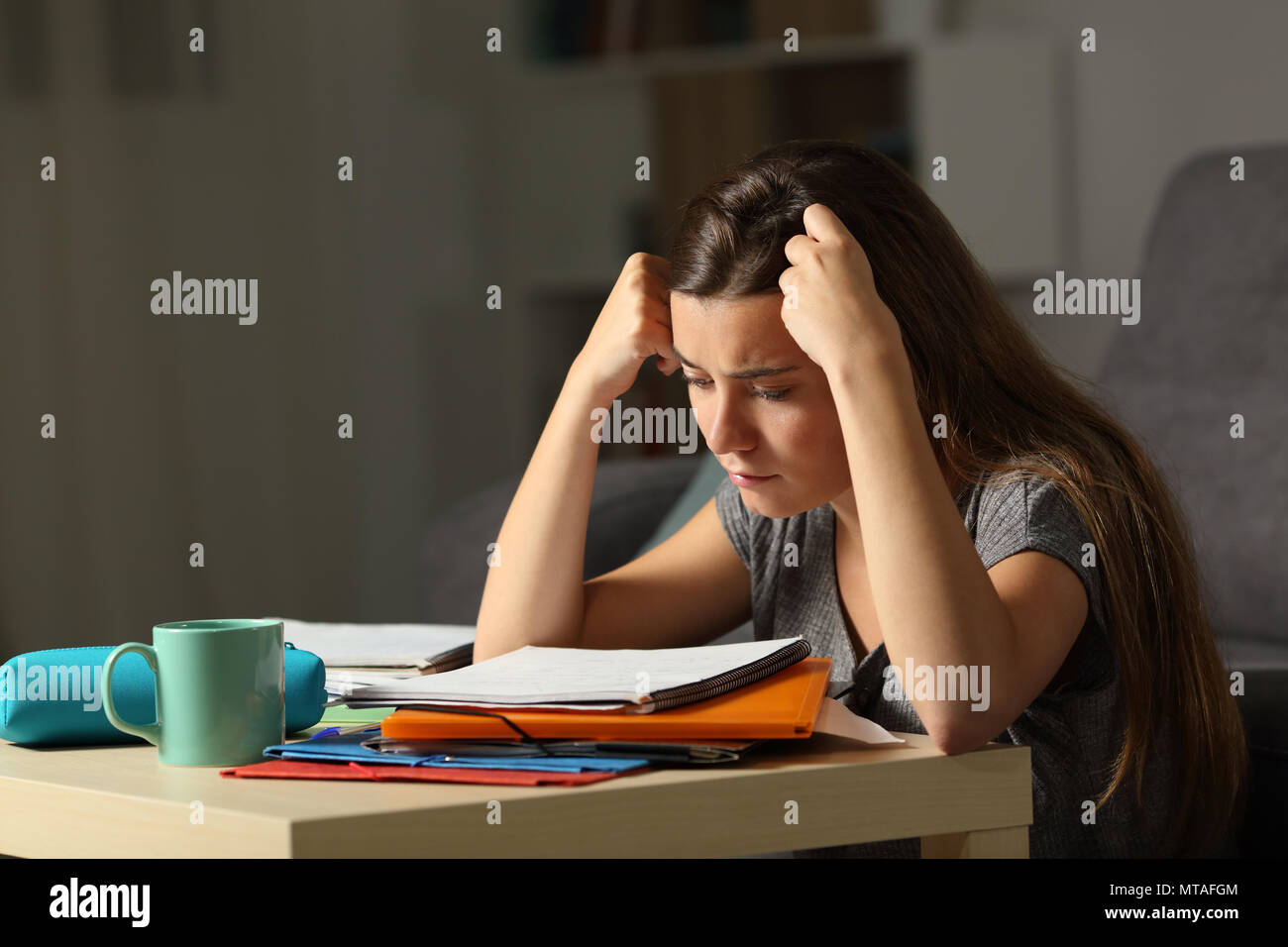 Studious student studying hard late hours in the night at home Stock Photo