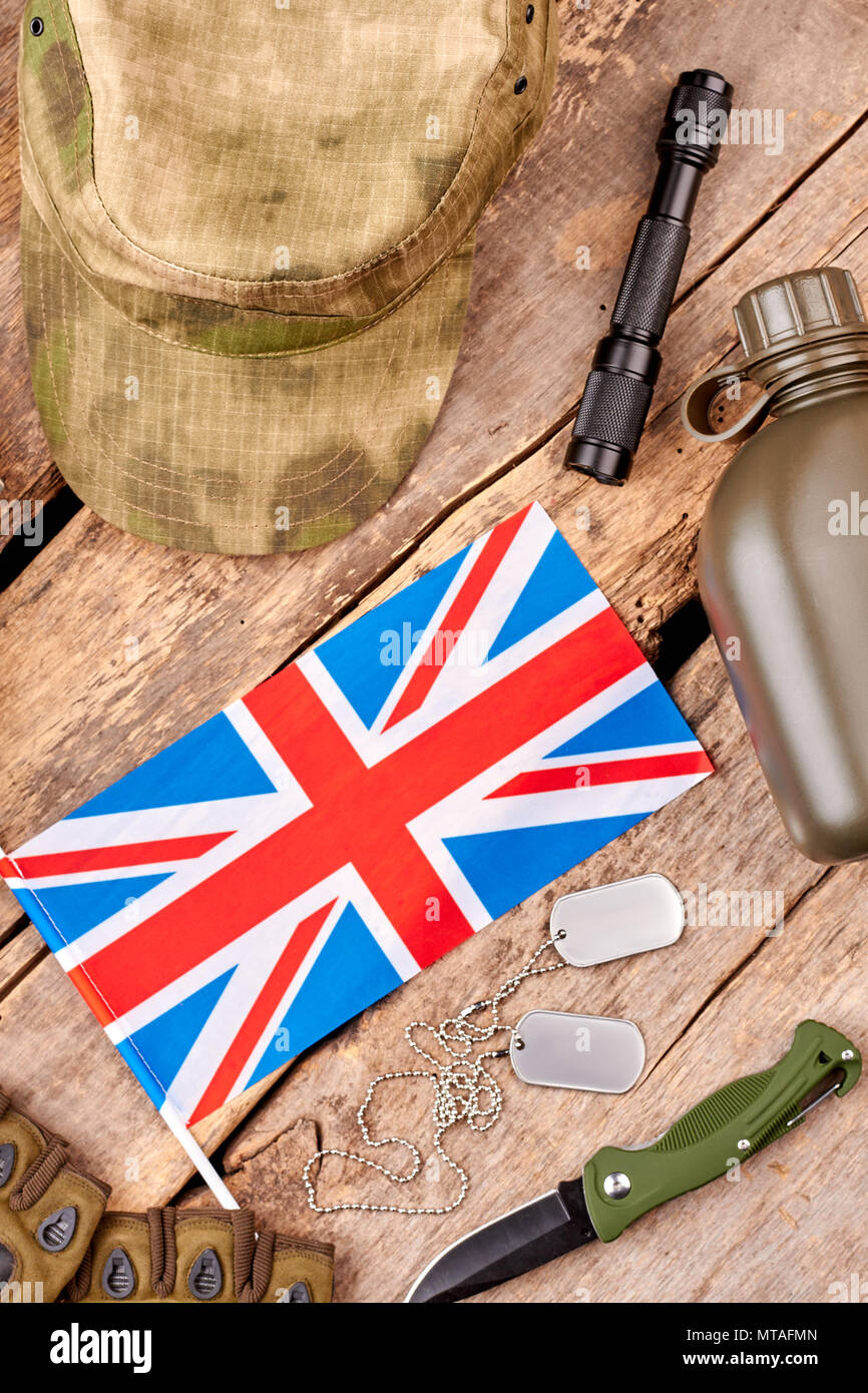 British army equipment flat lay. Top view. Wooden background Stock