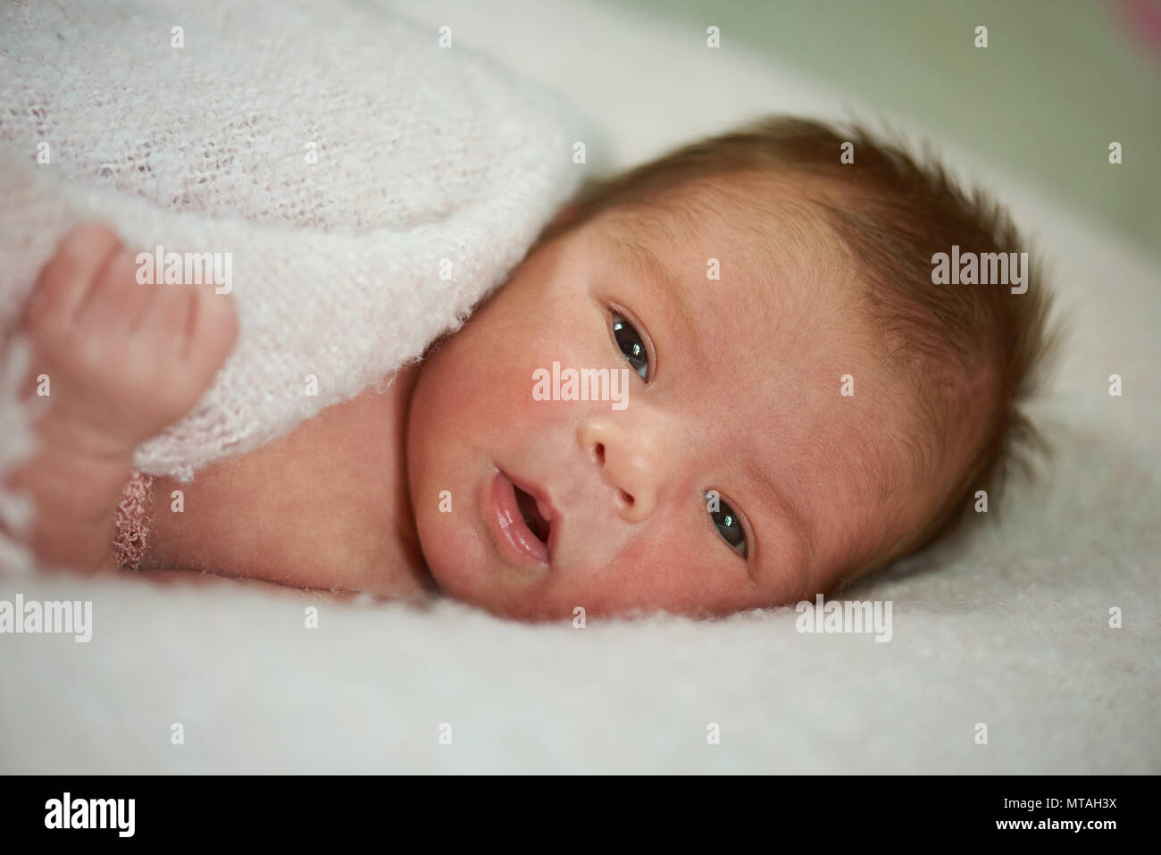 Clean awake newborn baby close up portrait on soft background Stock Photo