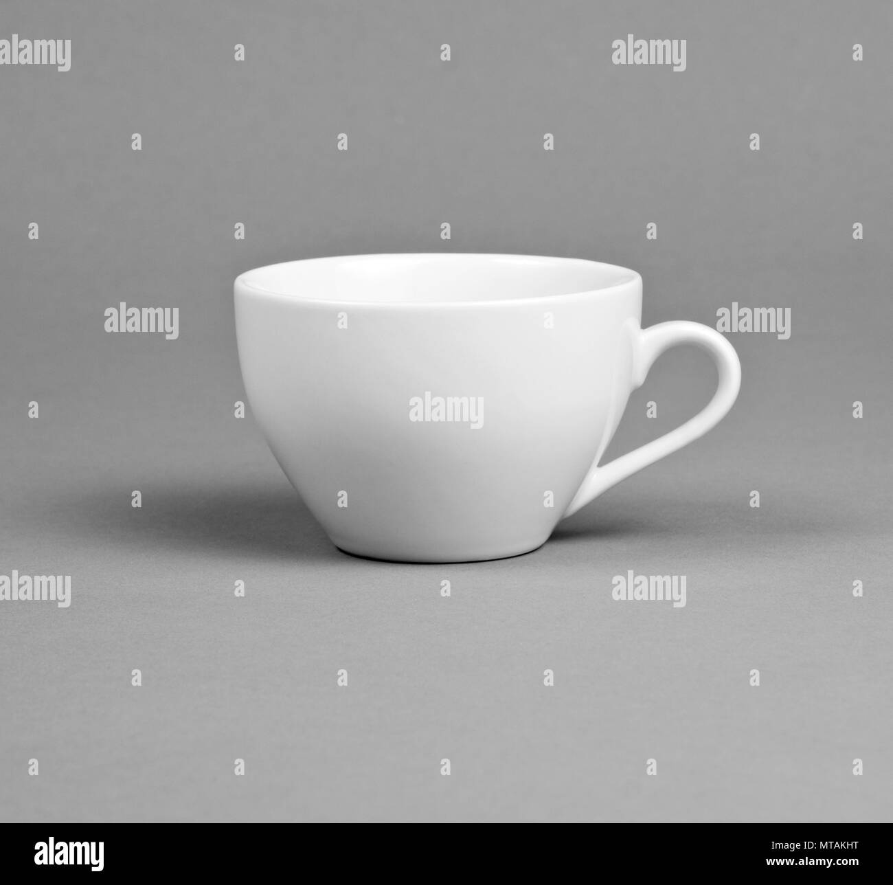 Small white coffee cup on a gray background Stock Photo Alamy