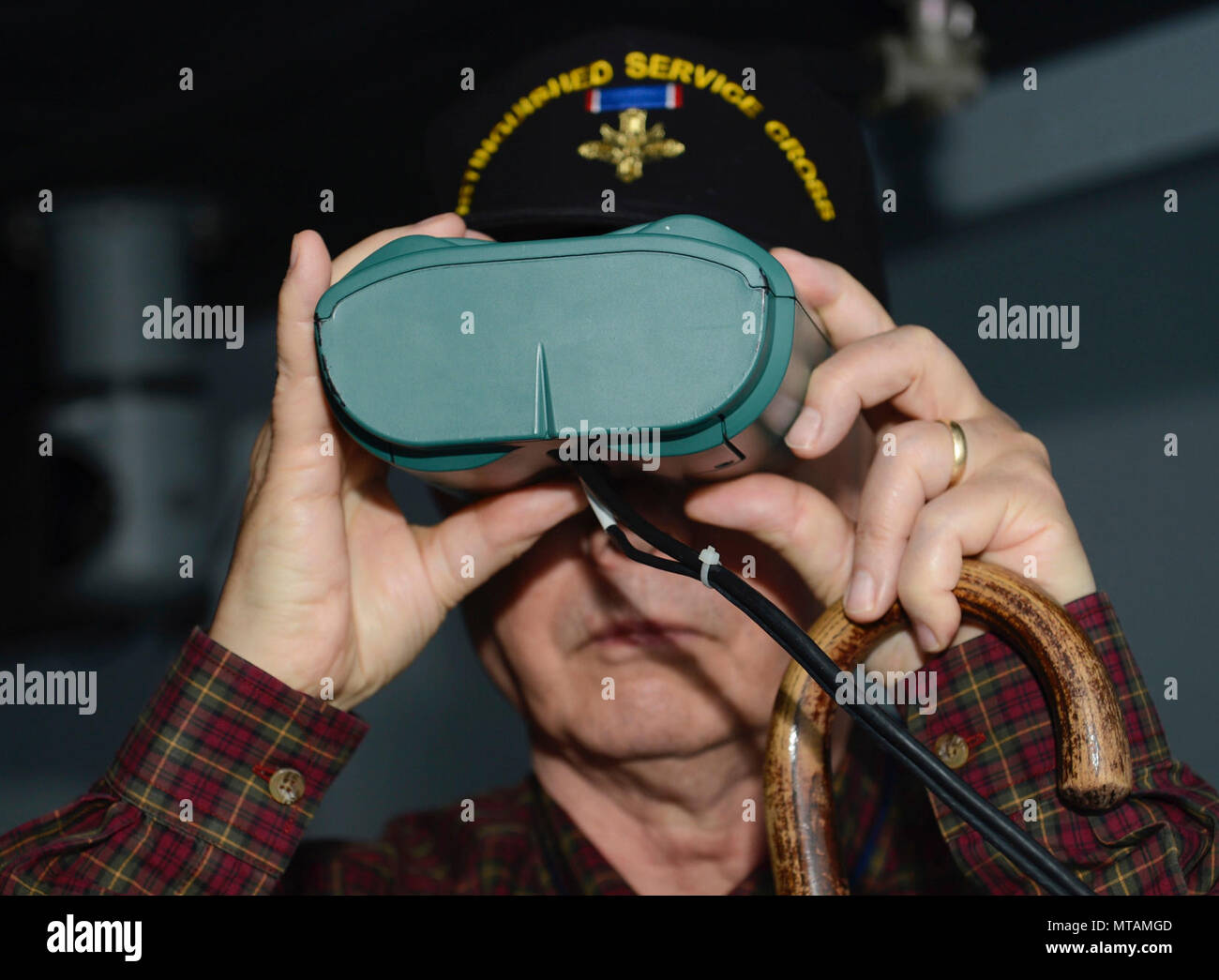Retired U.S. Army 1st Sgt. Claude Quick, Legion of Valor member, looks through simulation binoculars at the Maritime Intermodal Training Department while on a tour at Joint Base Langley-Eustis, Va., April 21, 2017. Each year, members of the Legion of Valor gather for an annual convention to enhance their understanding of current military affairs and provide mentorship from personal accomplishments or failures. Stock Photo