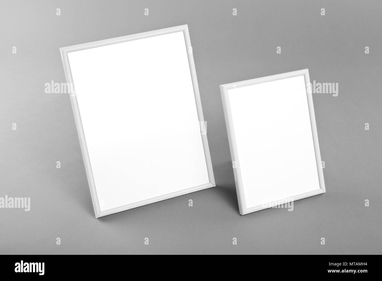 White frames for paintings or photographs on gray background Stock