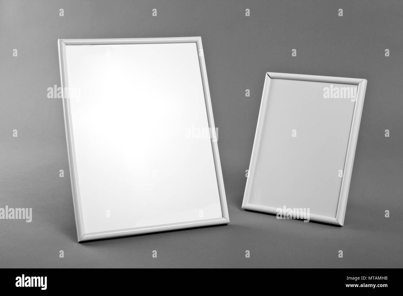 White frames for paintings or photographs on gray background Stock Photo Alamy
