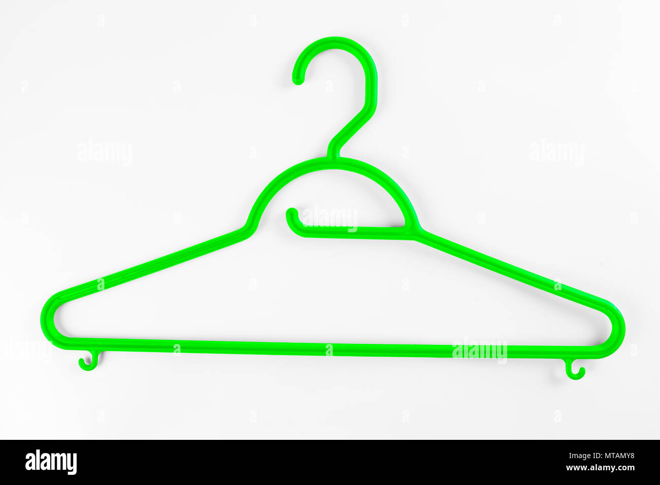 Green plastic hanger for clothes on a white background Stock Photo