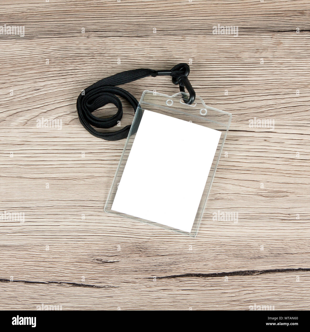 Name id card badge with cord on wooden background Stock Photo Alamy