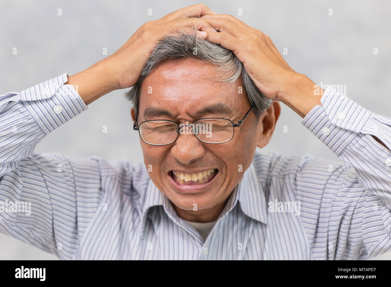 Asian elder suffer from stroke and powerful headache or brain attack Stock Photo