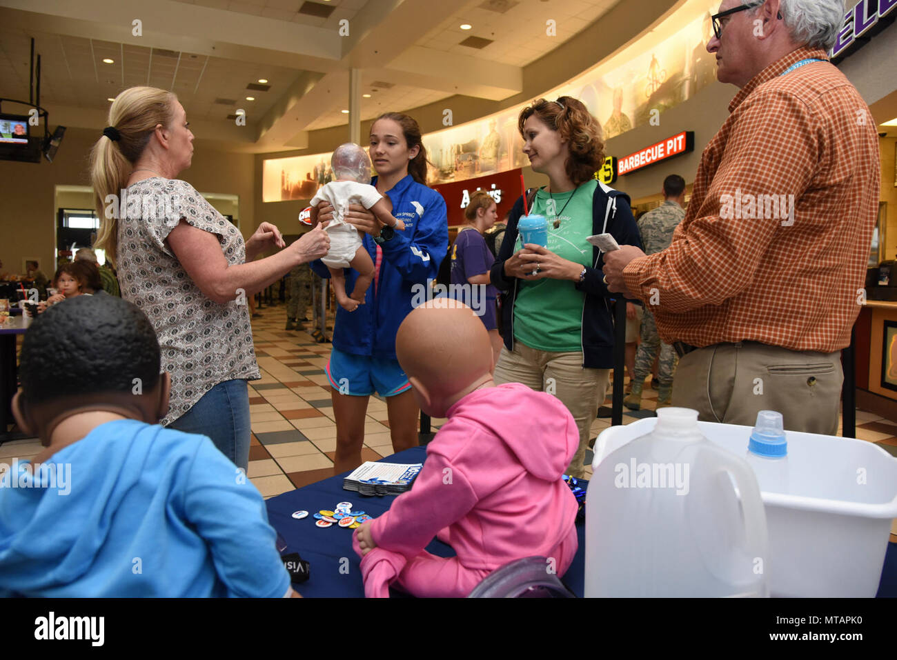 Paula Spooner, 81st Medical Operations Squadron family advocacy outreach manager, conducts a shaken baby syndrome simulation in the base exchange April 21, 2017, on Keesler Air Force Base, Miss. The family advocacy staff manned a booth with hand-outs and reading material about child abuse prevention for Keesler personnel in recognition of Child Abuse Prevention Month. Stock Photo