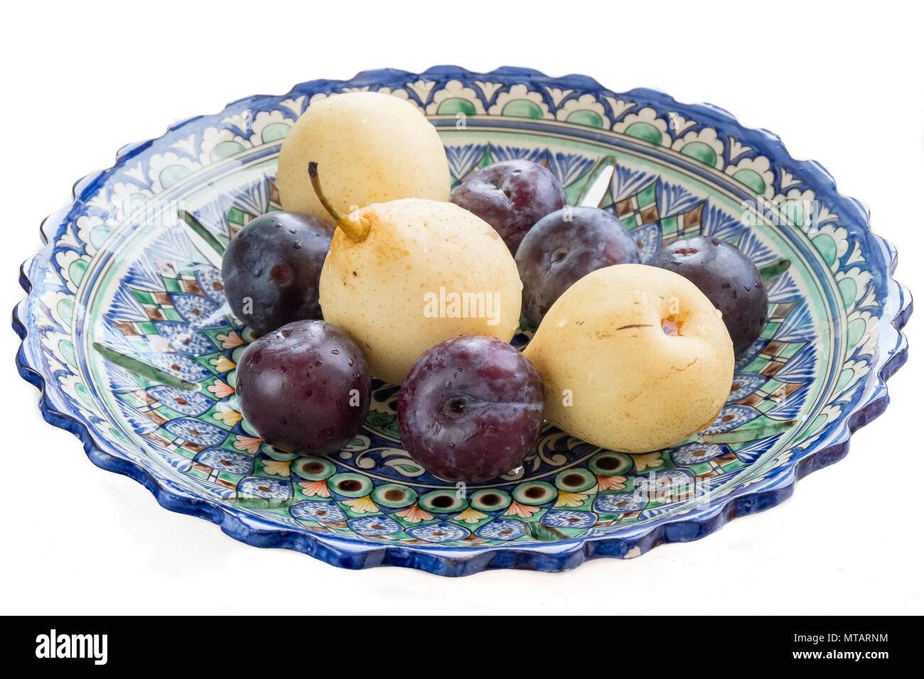 Pears and plums in an Uzbek bowl Stock Photo