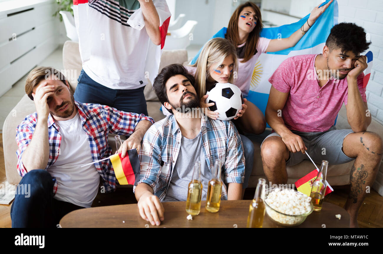 Group of friends sport fans watching match disappointed Stock Photo