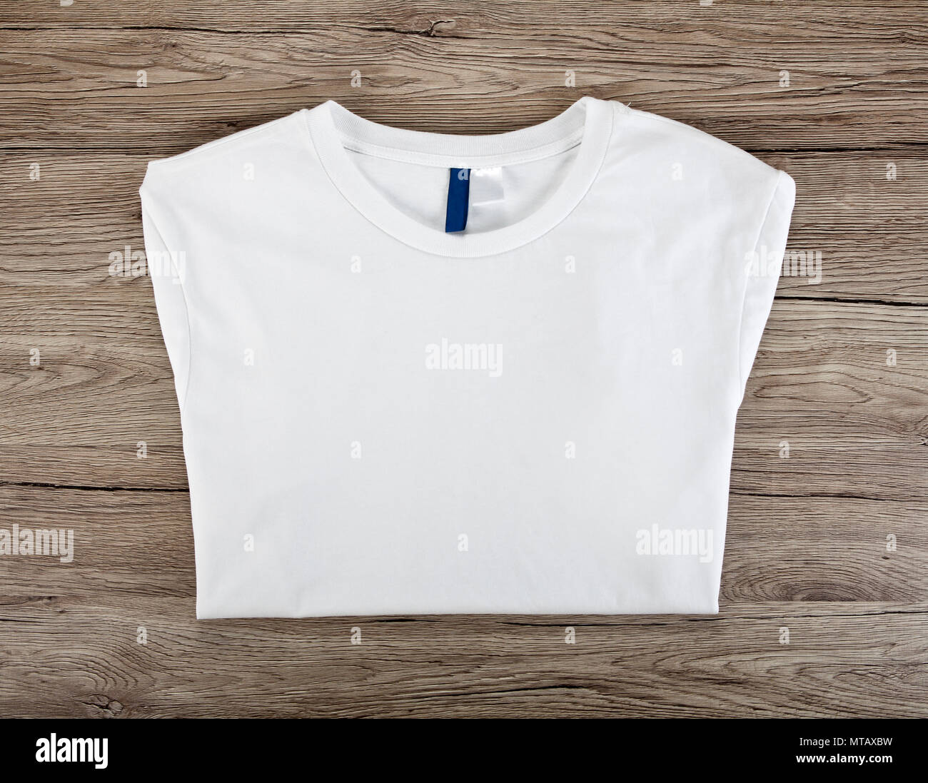 Download White Folded T Shirt Template On A Wooden Background Stock Photo Alamy