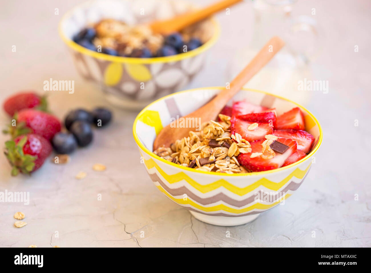 Healthy breakfast muesli bowls with strawberries slices , tasty granola breakfast Stock Photo