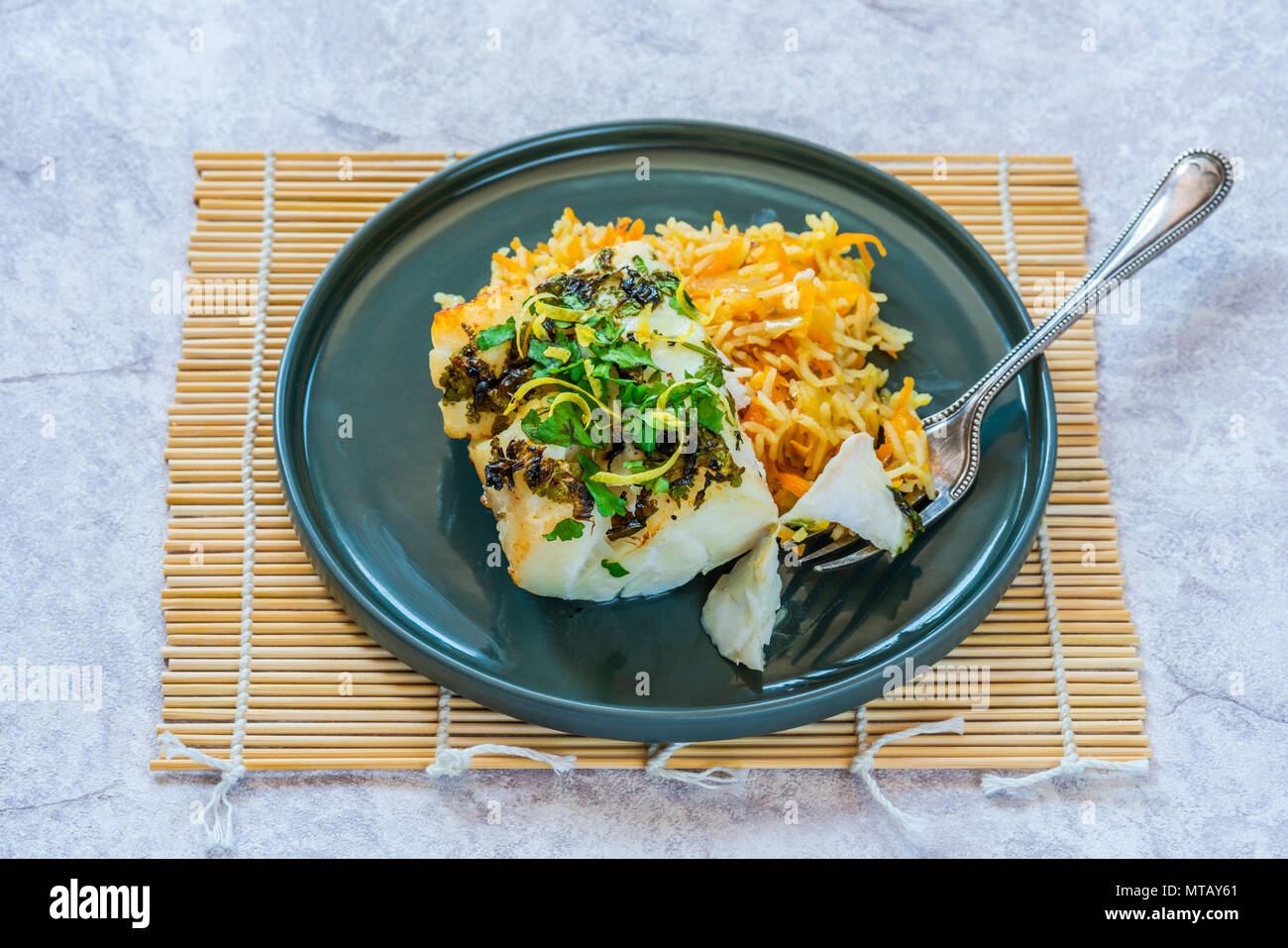 Grilled coriander and lemon cod with carrot pilaf Stock Photo Alamy