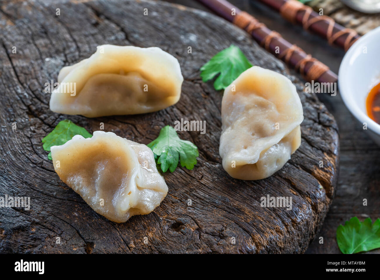 Chinese pork dumplings dim sum with sweet chili dipping sauce Stock