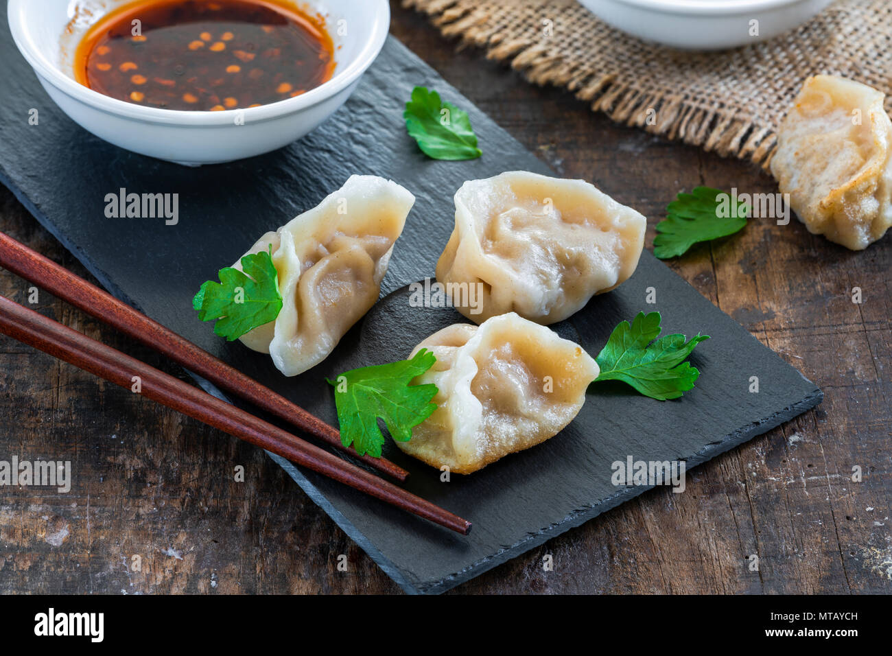 Chinese pork dumplings dim sum with sweet chili dipping sauce Stock