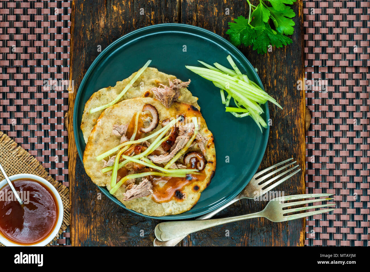 Crispy duck with pancakes, plum sauce, shredded cucumber and spring onion Stock Photo