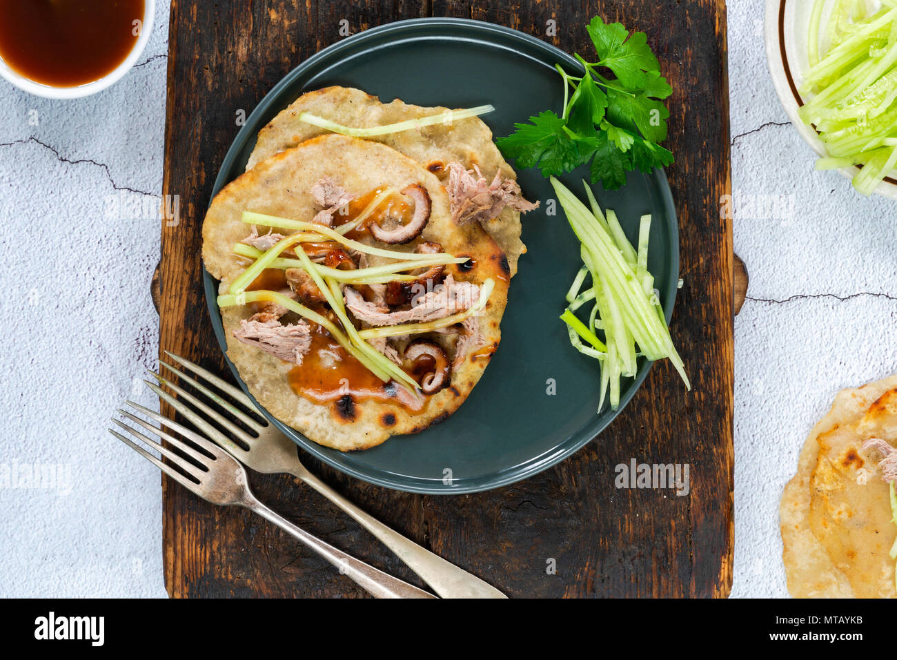 Crispy duck with pancakes, plum sauce, shredded cucumber and spring onion Stock Photo