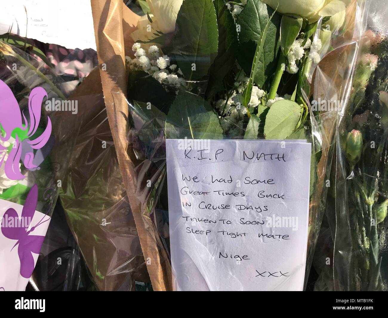 Floral tributes left at the scene where a 30-year-old man died after a car was driven into a group of people. A man has been arrested on suspicion of murder after a black Audi A4 hit a number of people outside the Salisbury Club in Brinnington, Stockport, Greater Manchester on Sunday. Stock Photo