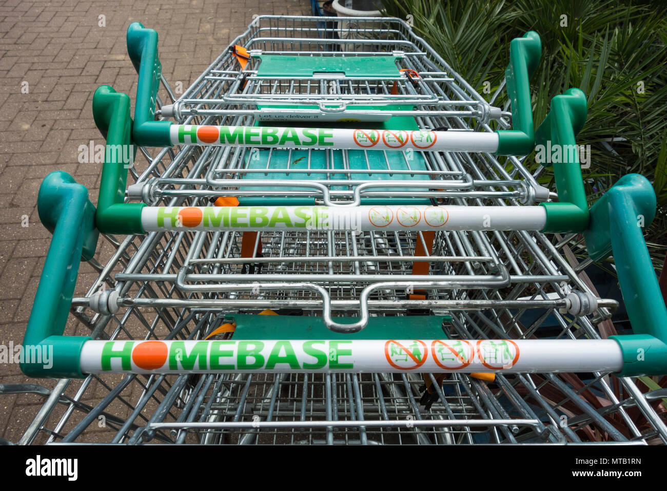 Trolleys stacked outside Homebase. Wesfarmers sells DIY chain to retail restructuring company Hilco for a sum of just £1 Stock Photo
