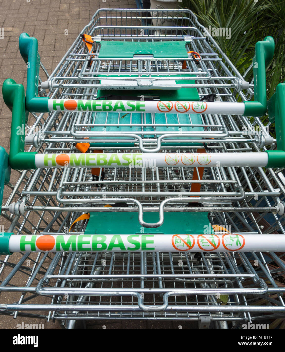 Trolleys stacked outside Homebase. Wesfarmers sells DIY chain to retail restructuring company Hilco for a sum of just £1 Stock Photo