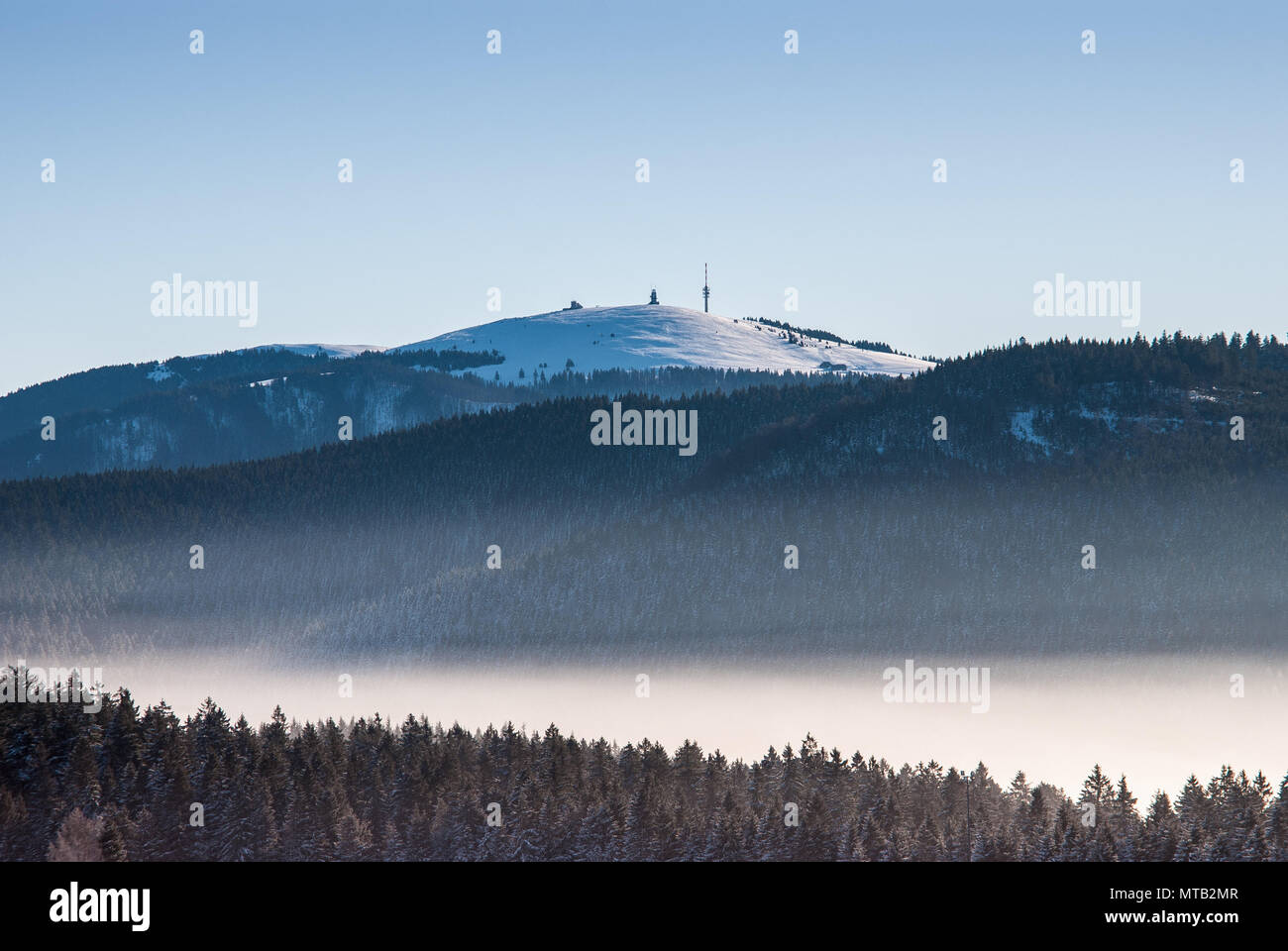 View from Schauinsland to Feldberg just obove the mist. Stock Photo