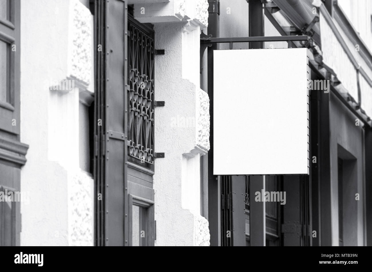 Blank square outdoor commercial signage mockup, black and white real architecture picture Stock Photo