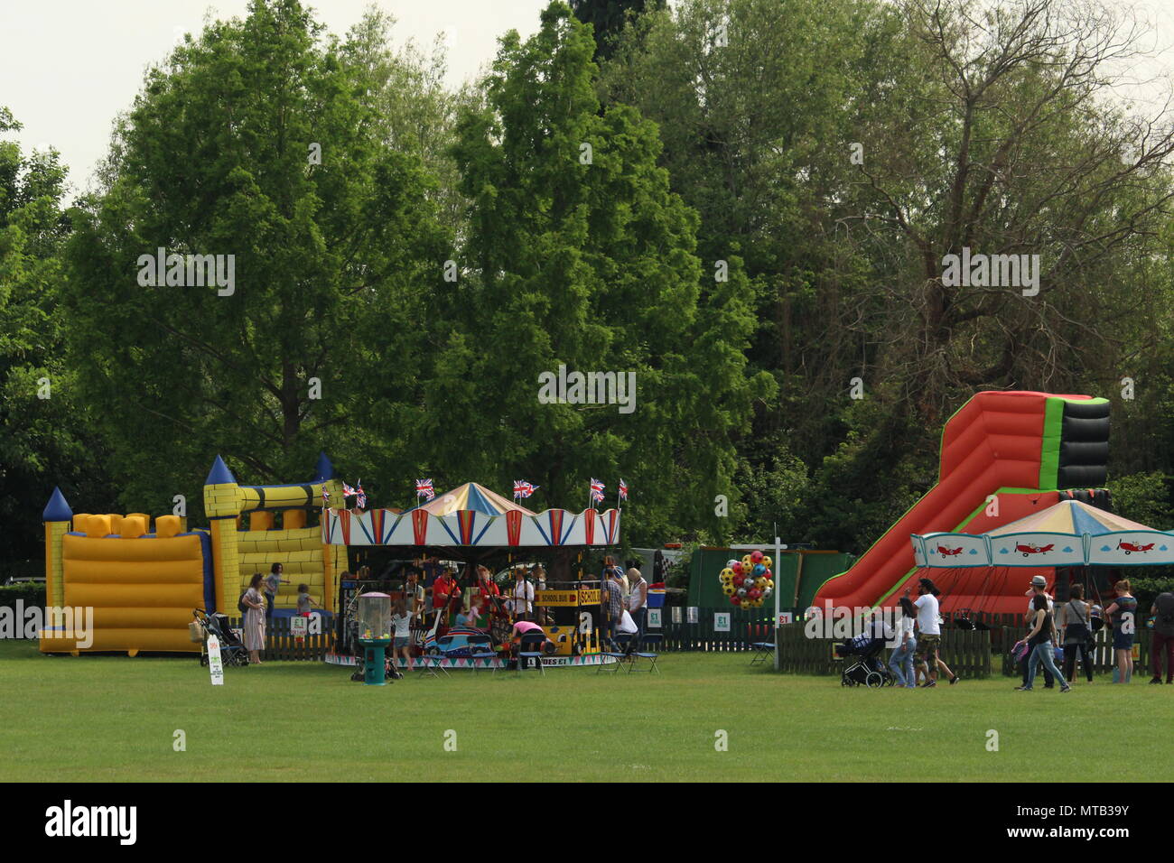Summer scenes - families at the fun fair at Henley on Thames village green. No model or property releases. Stock Photo