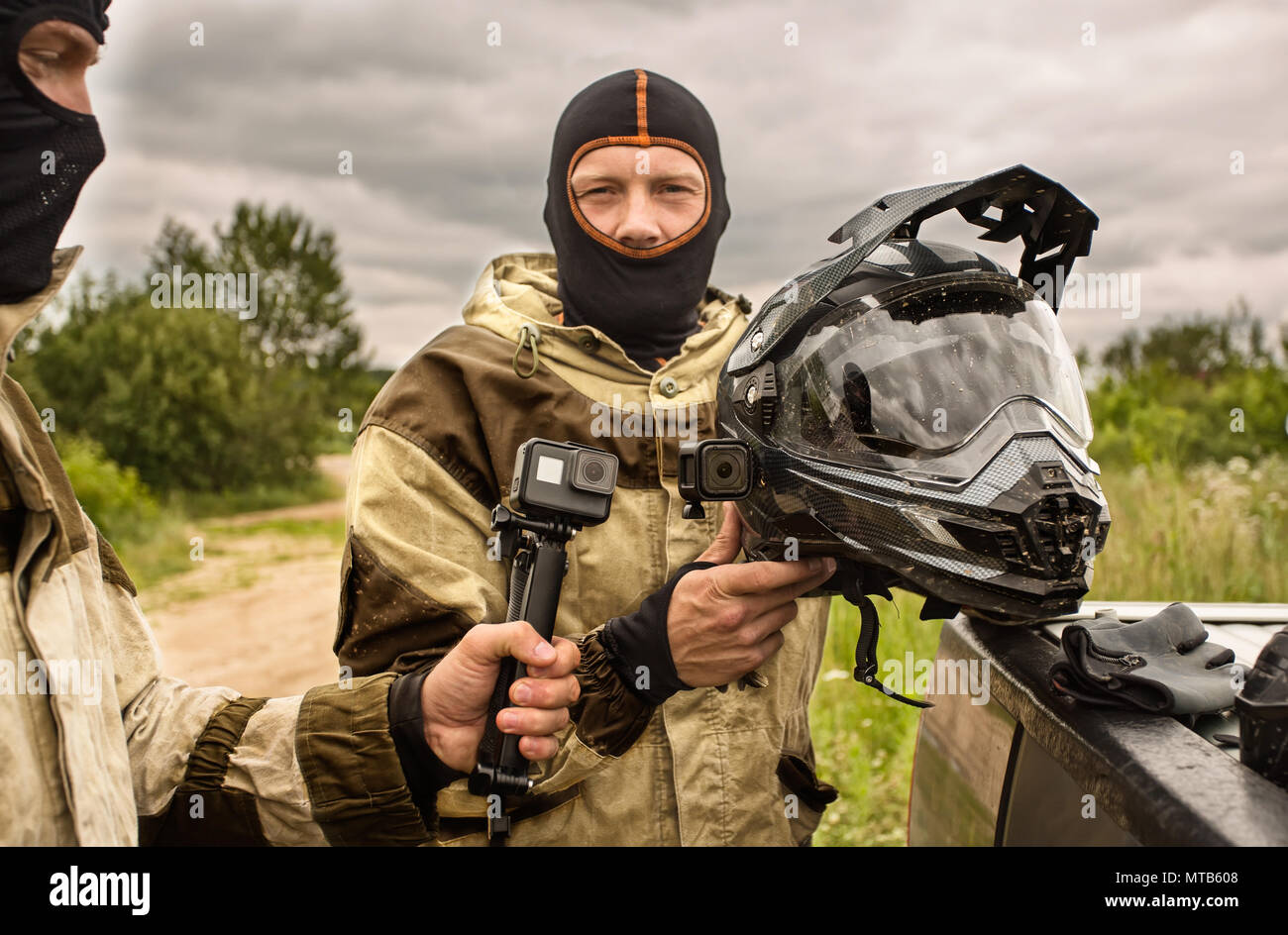 Close up of Two men outdoors wearing balaclava helmets and motor Stock Photo