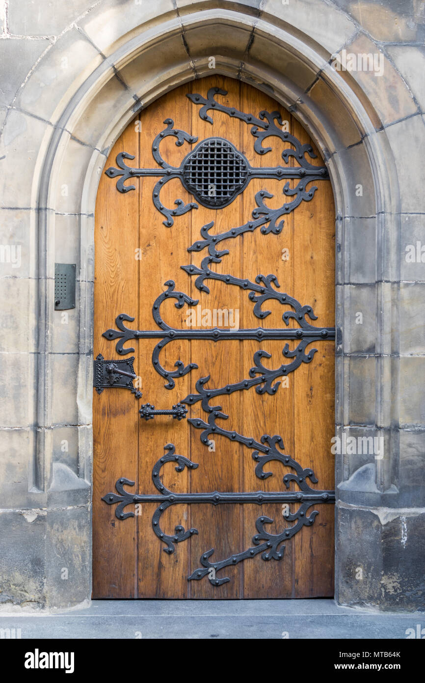 Old wooden doors with metal ornaments on the Vitus cathedral in Prague Stock Photo