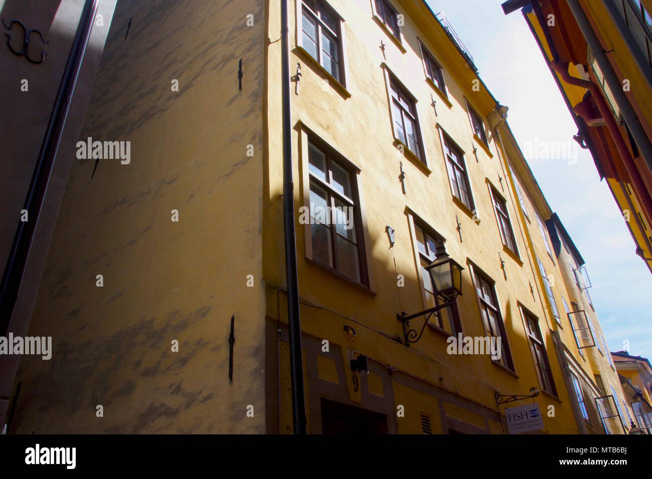 A yellow building in Gamla Stan, Stockholm which features building anchor plates Stock Photo