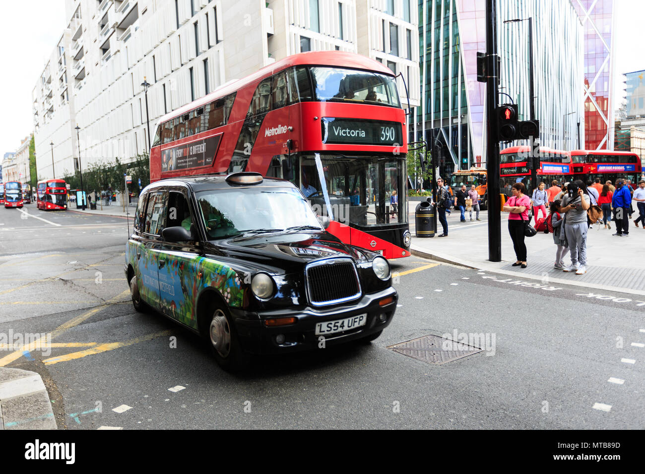 Legendary London taxi cab and red bus on the streets of London Stock ...