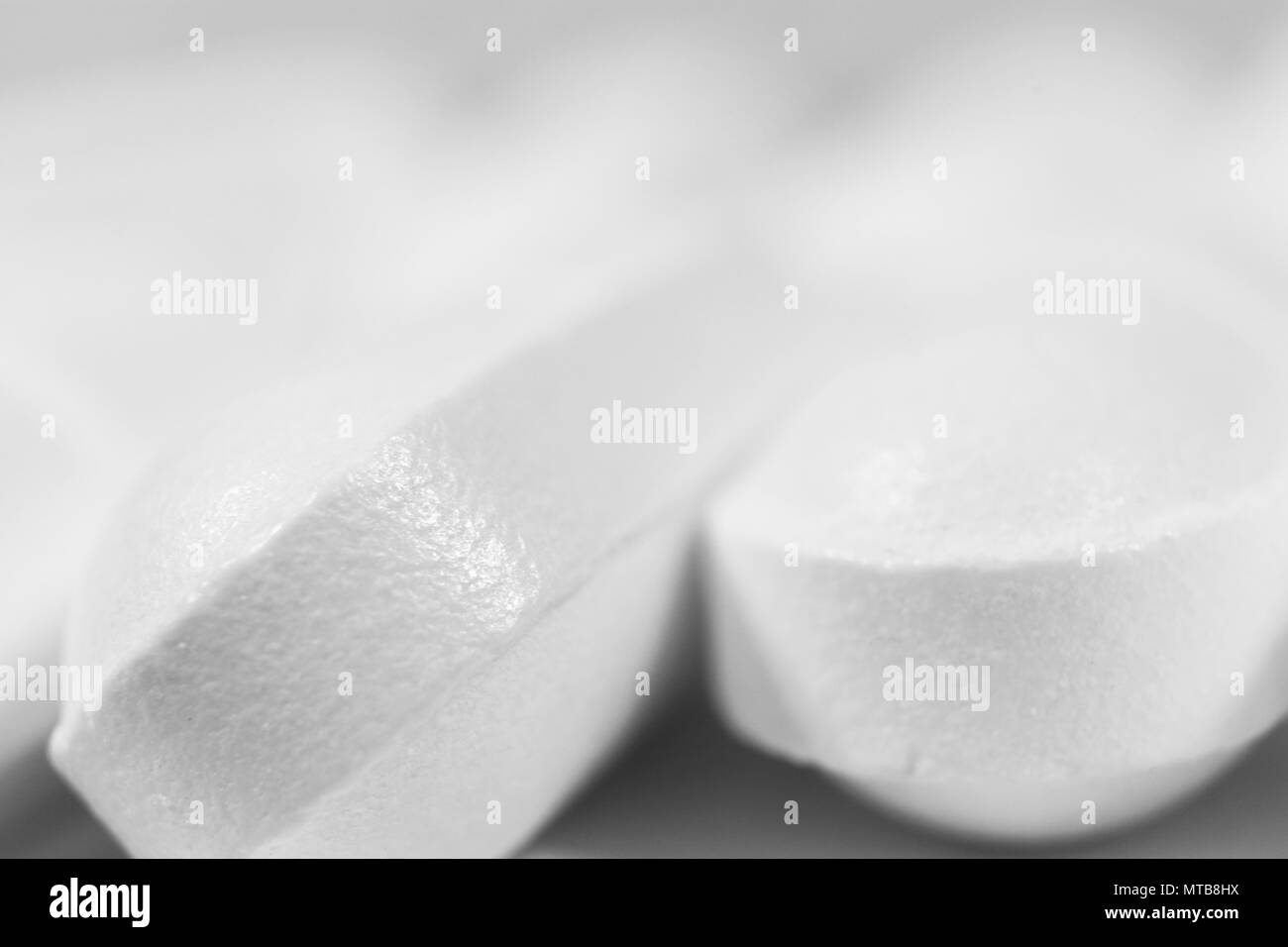 Two White Medicine Tablets. Pharmacy Pills Background. Place for Text. Macro Closeup. Stock Photo