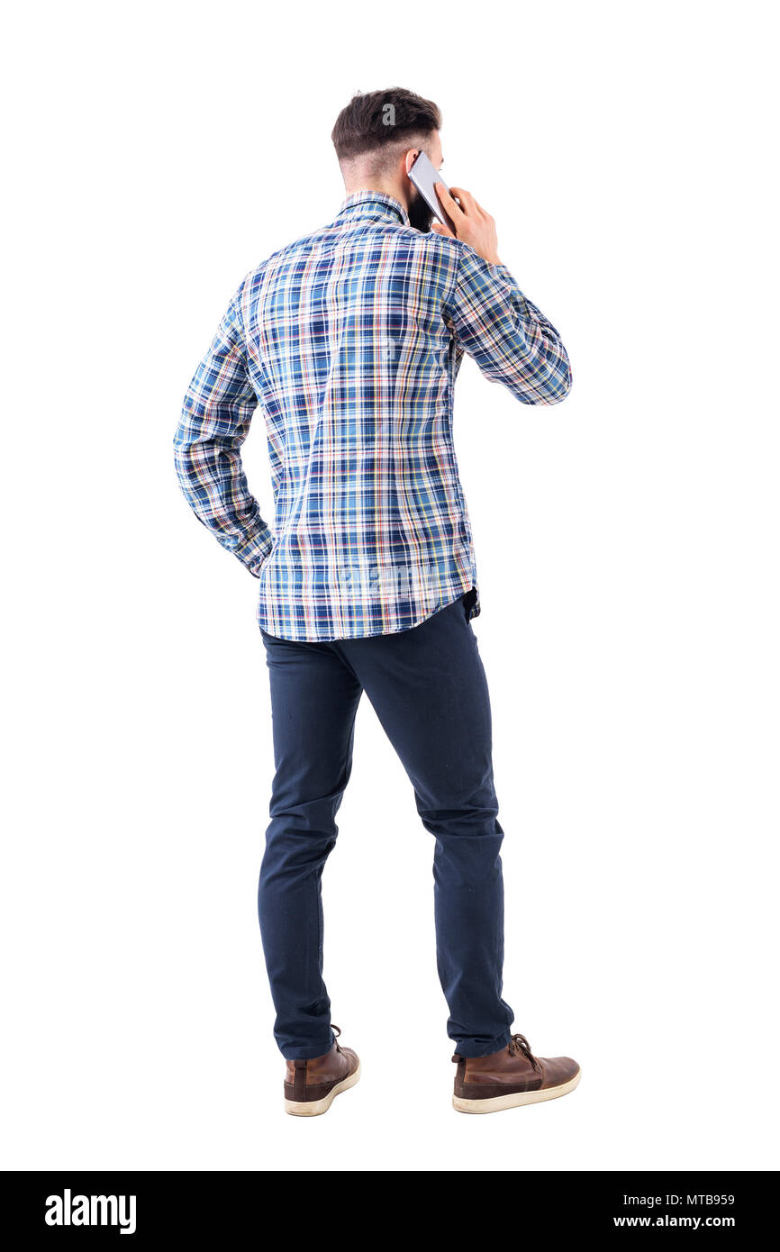 Rear view of young smart casual business man talking on the cellphone ...
