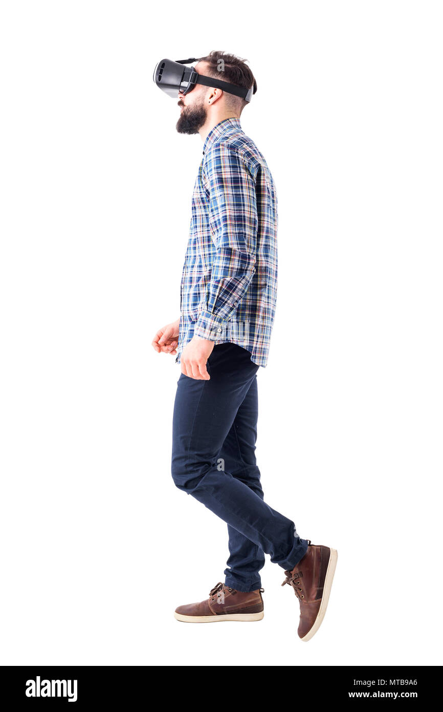 Profile view of business man watching virtual reality headset walking