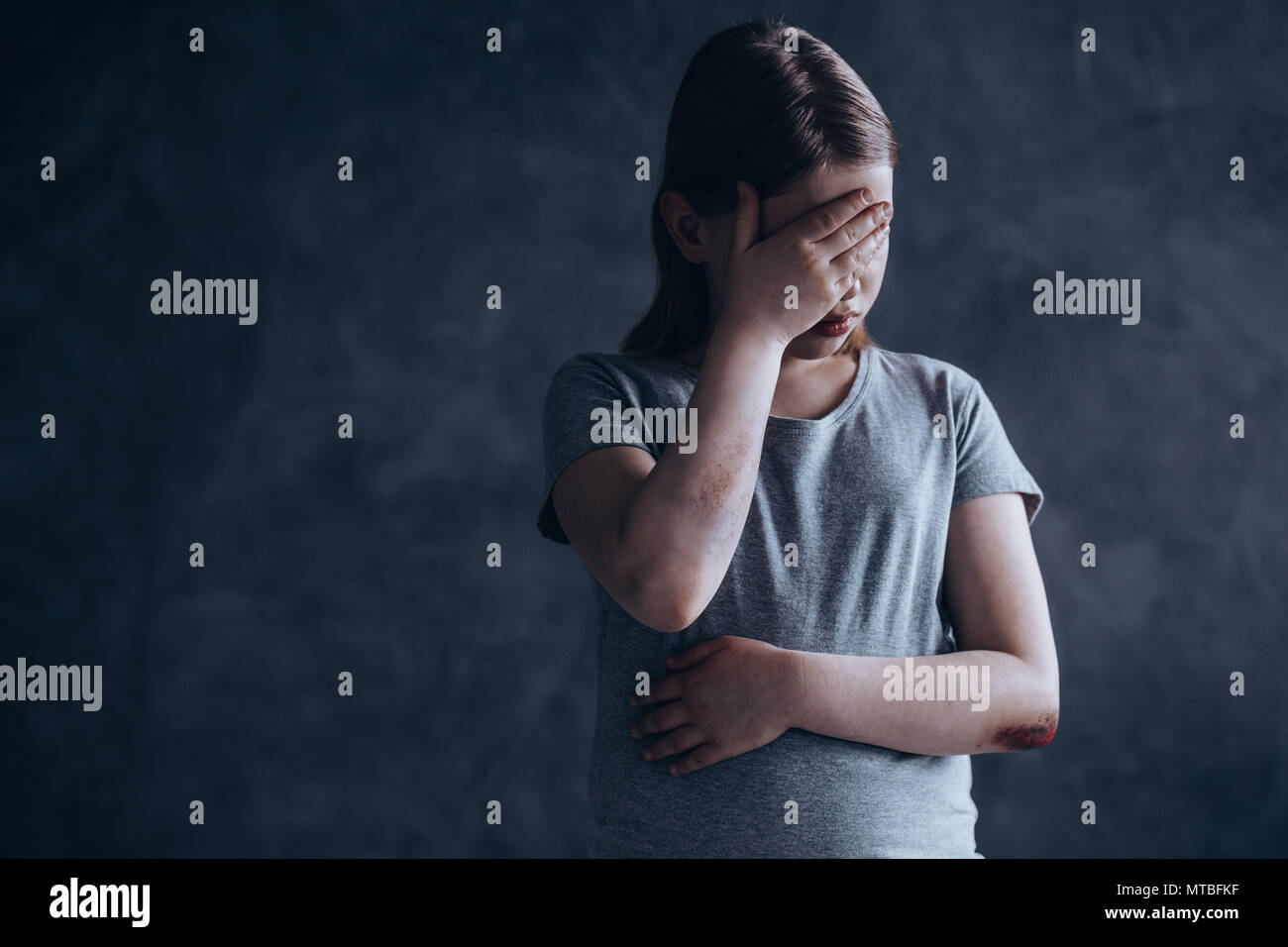Little girl being a victim oh her sociopath father Stock Photo