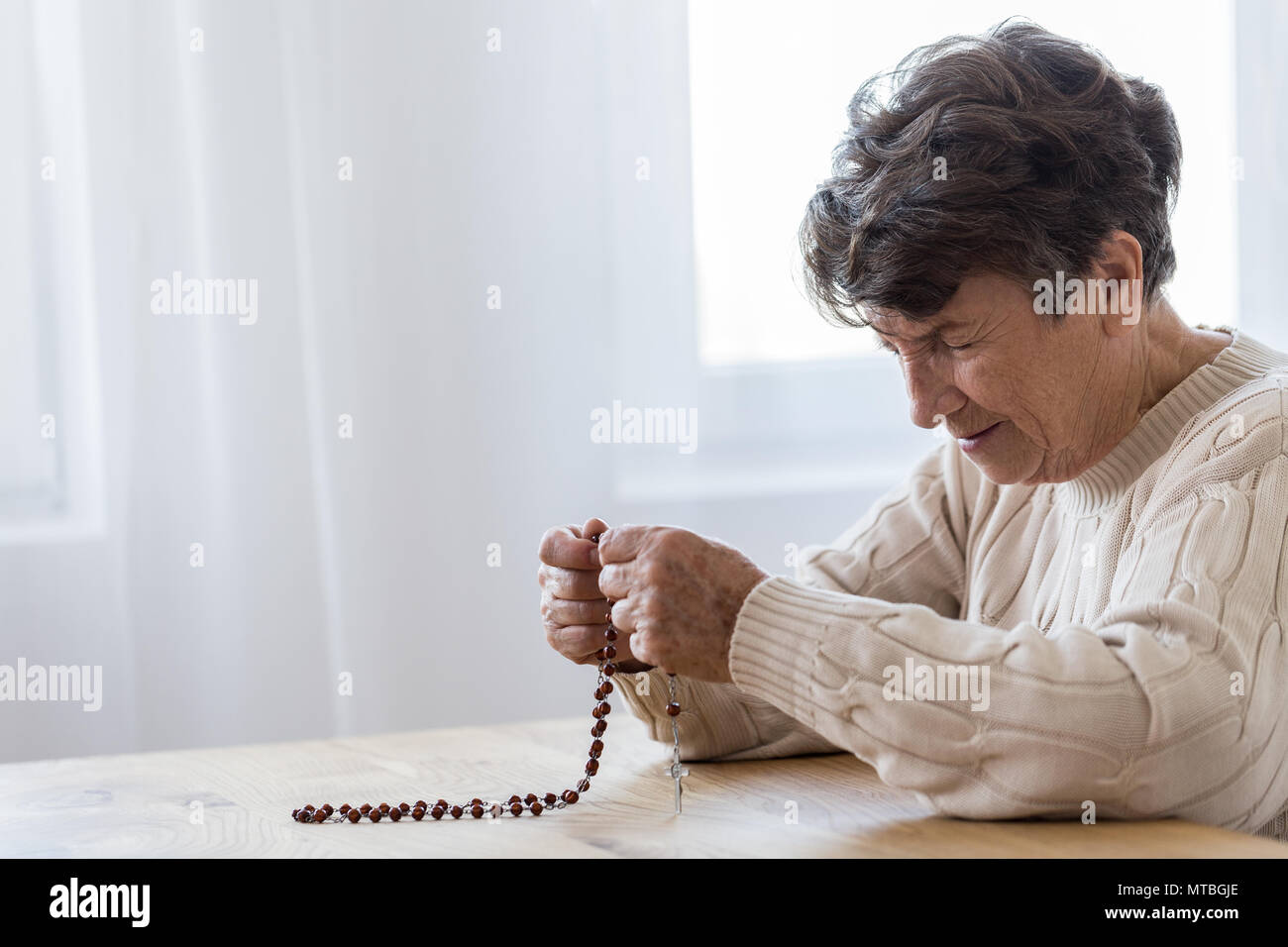 An old woman with a rosary hi-res stock photography and images - Alamy