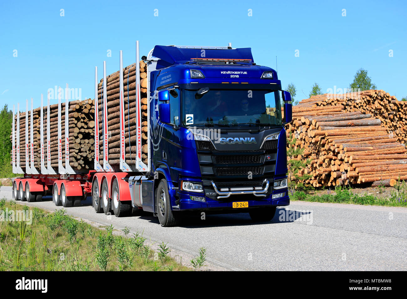 Blue Next Generation Scania R730 logging truck on test drive by logging site on a sunny day during Scania Tour 2018 in Lohja, Finland - May 25, 2018. Stock Photo