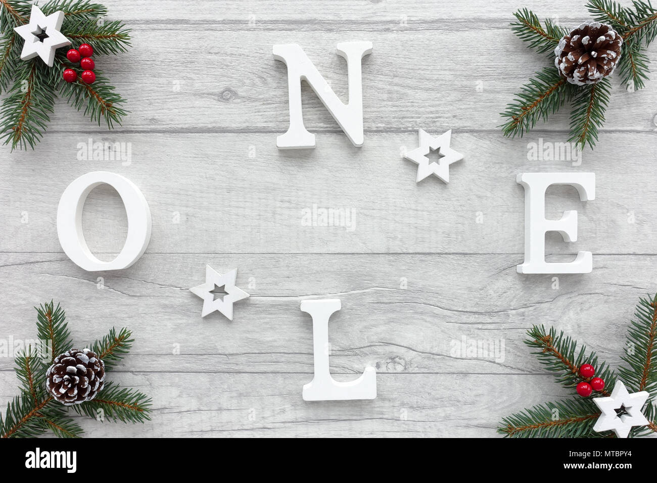 Noel Written With White Wooden Letters On Wood Background