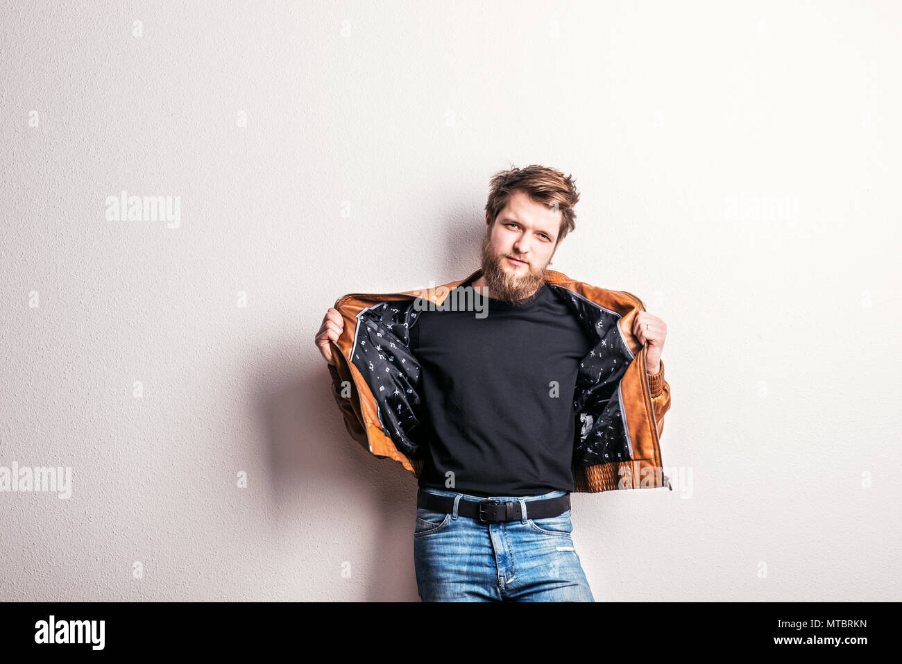 Portrait of a young hipster man in a studio. Copy space. Stock Photo