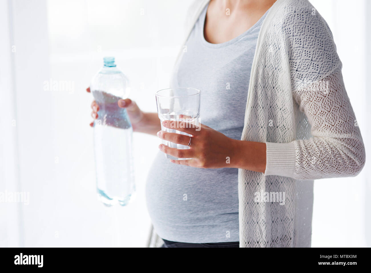 Unrecognizable pregnant woman drinking water Stock Photo Alamy
