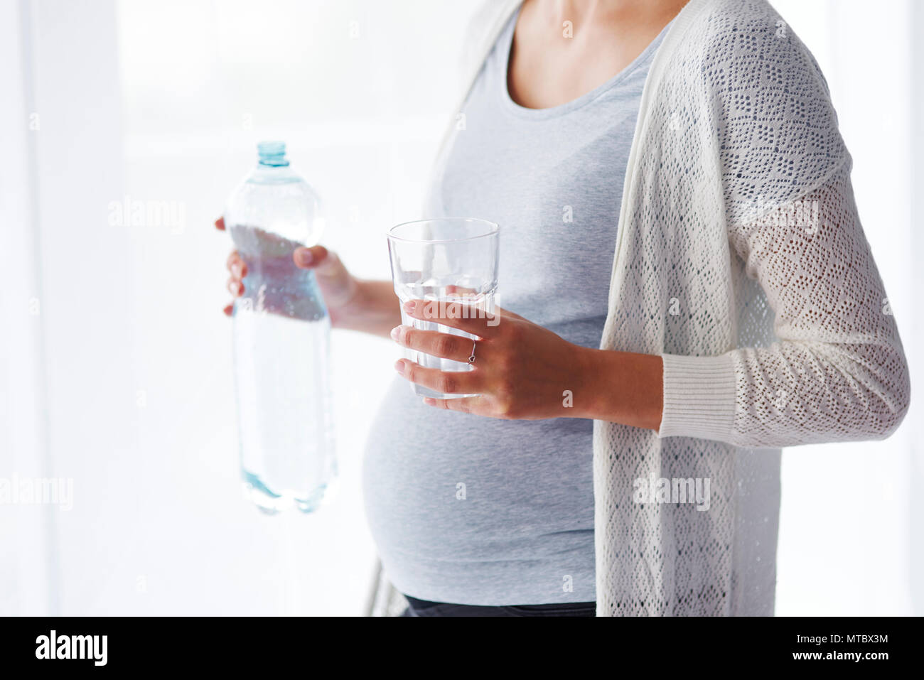 Unrecognizable pregnant woman drinking water Stock Photo