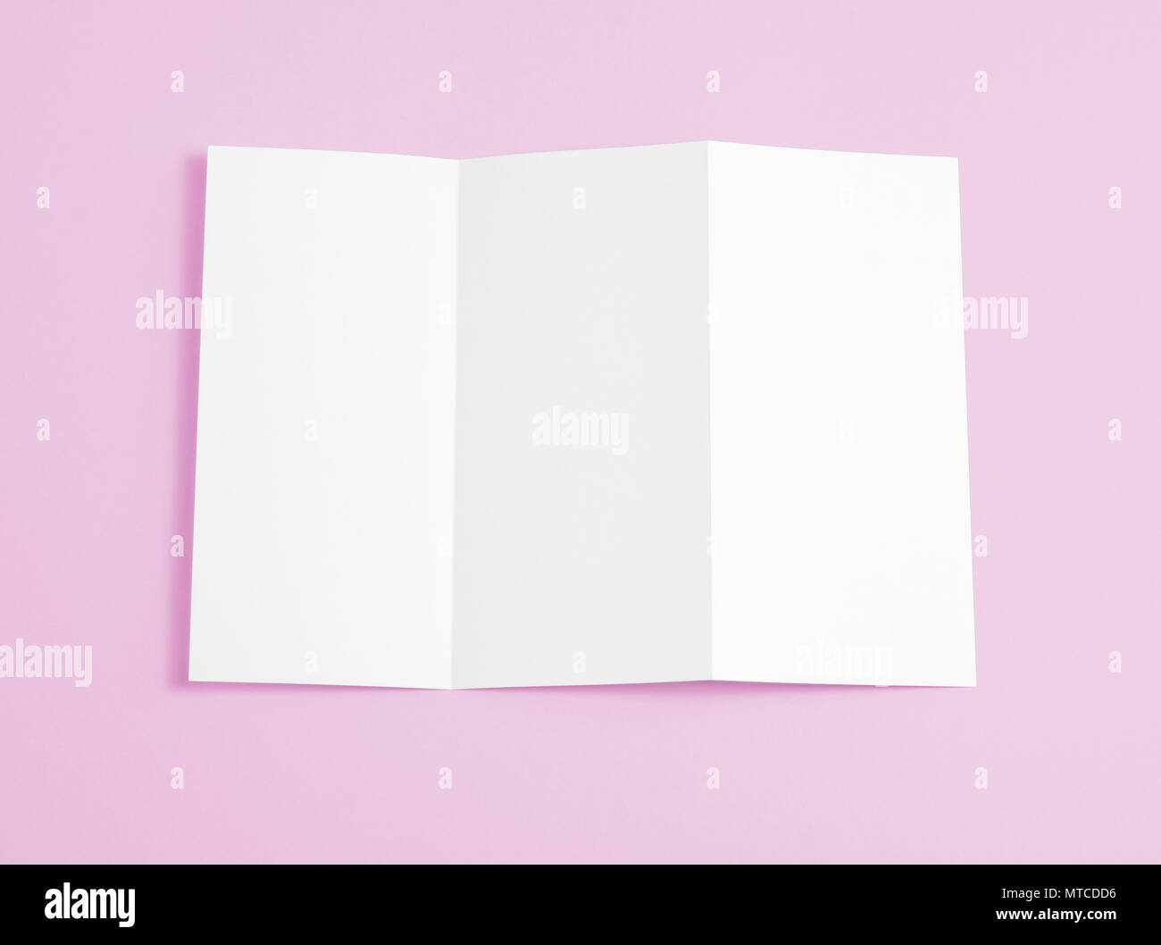 Blank folding page booklet on pink background Stock Photo