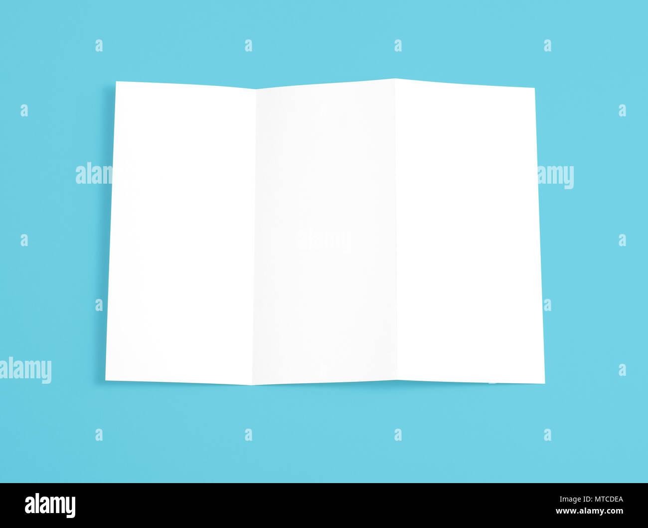 Blank folding page booklet on blue background Stock Photo