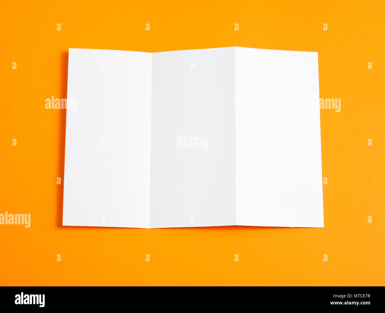 Blank folding page booklet on orange background Stock Photo