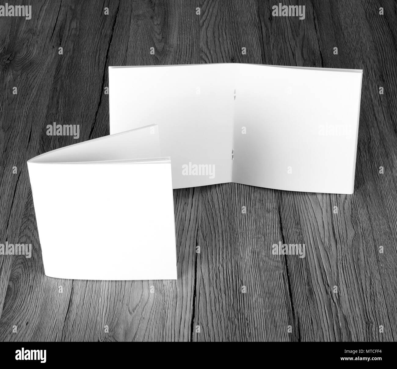 Blank catalog, brochure, magazines, book on wooden background, top view
